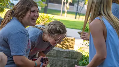 Group of students laugh together outside the University Center