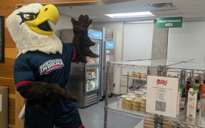 Archie pointing to the "Archie's Pantry" sign