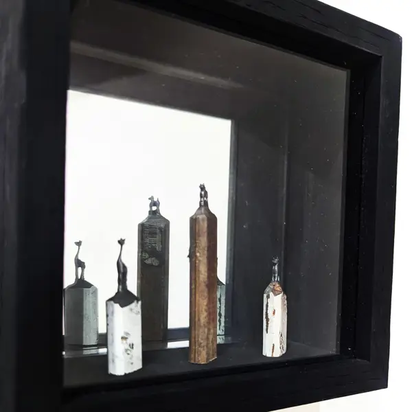 Artwork of cat sculptures in a shadowbox