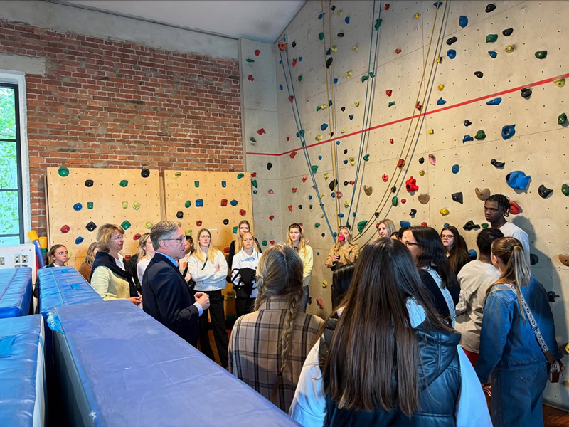 Students standing in front of a rock wall in Germany