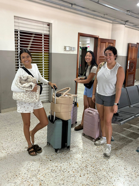 Three OT students with luggage at airport
