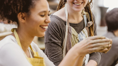 Two female students make pottery