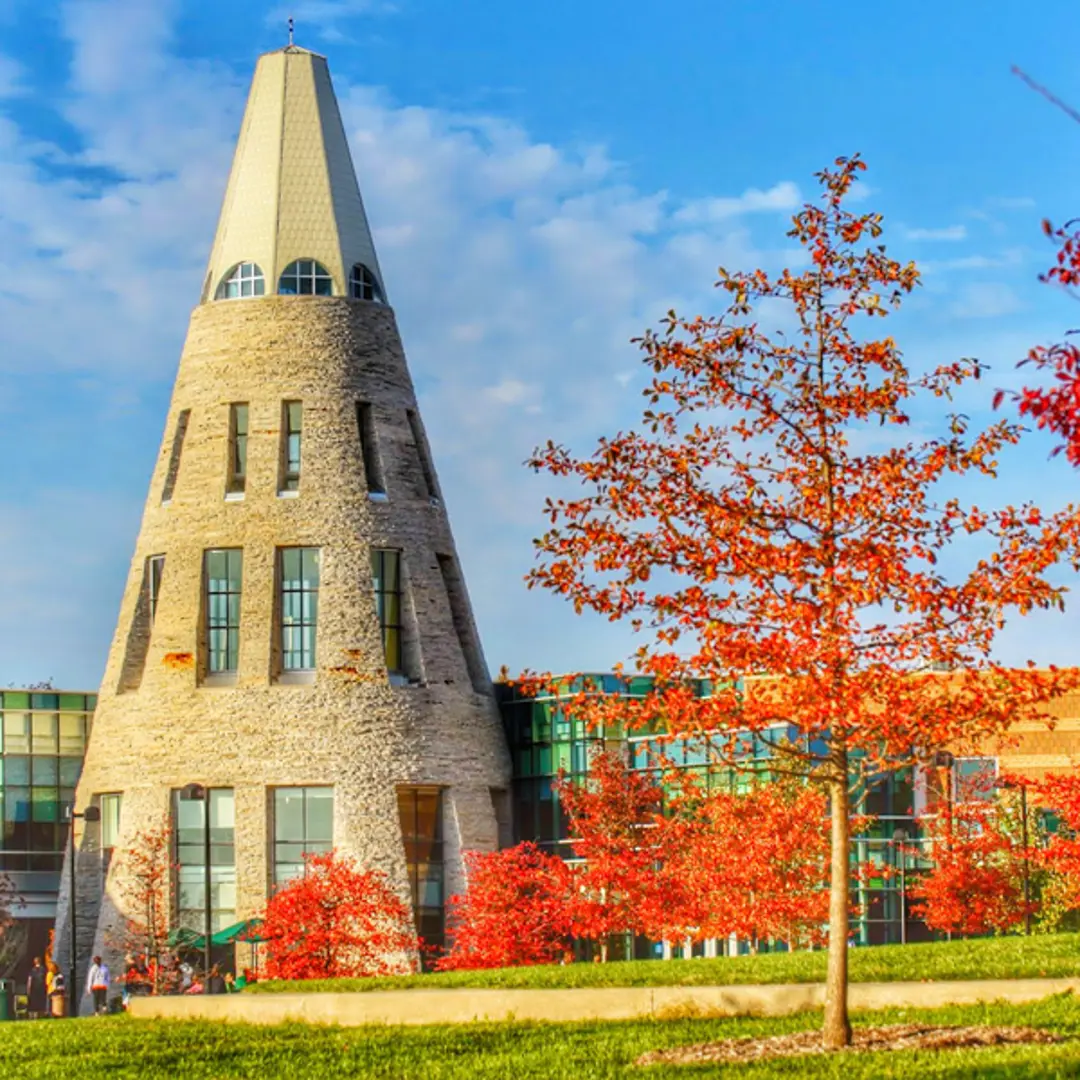 Exterior view of the University Center Tower with trees with fall colors
