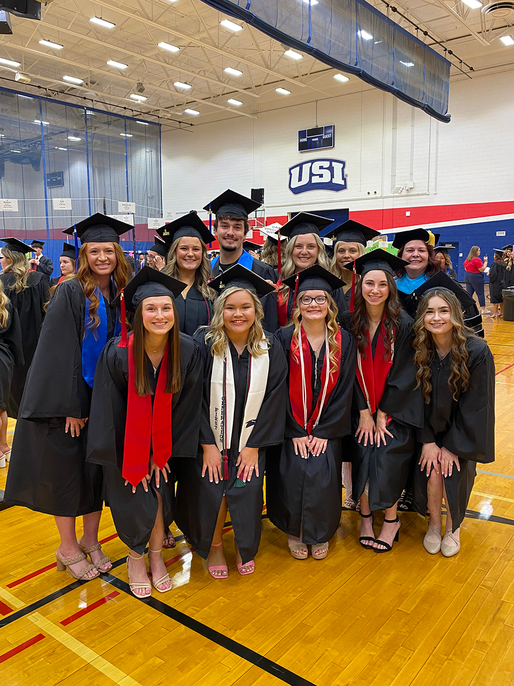 Diagnostic Medical Sonography students at graduation in caps and gowns