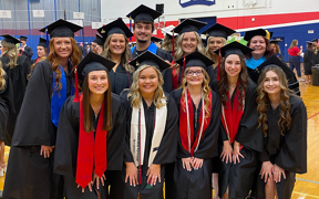 Diagnostic Medical Sonography students at graduation in caps and gowns