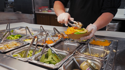 dining hall team member preparing a meal