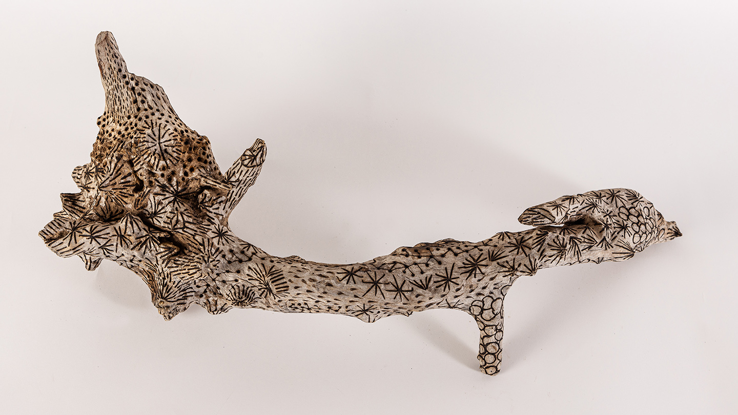 tattooed wood art piece