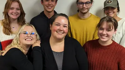 Student members of the math club pose for a photo with their faculty advisor
