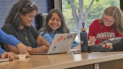 A group of students work on homework together