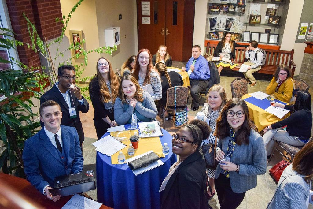 Group of students at a networking event smiling at the camera