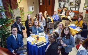 Group of students at a networking event smiling at the camera