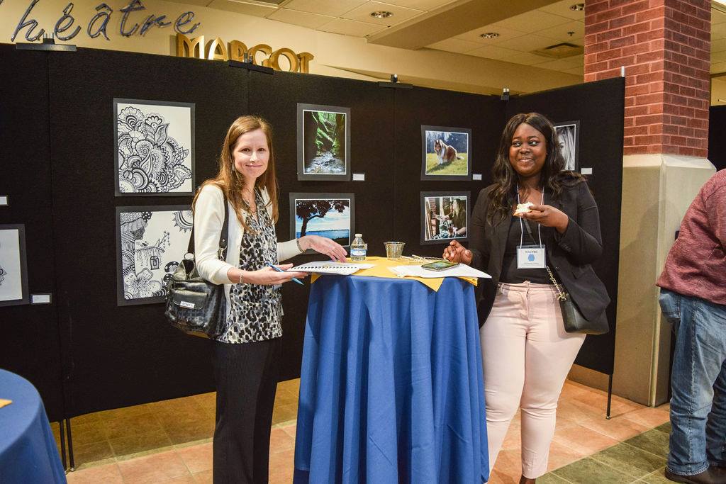 USI psychology faculty member poses with a student at an event