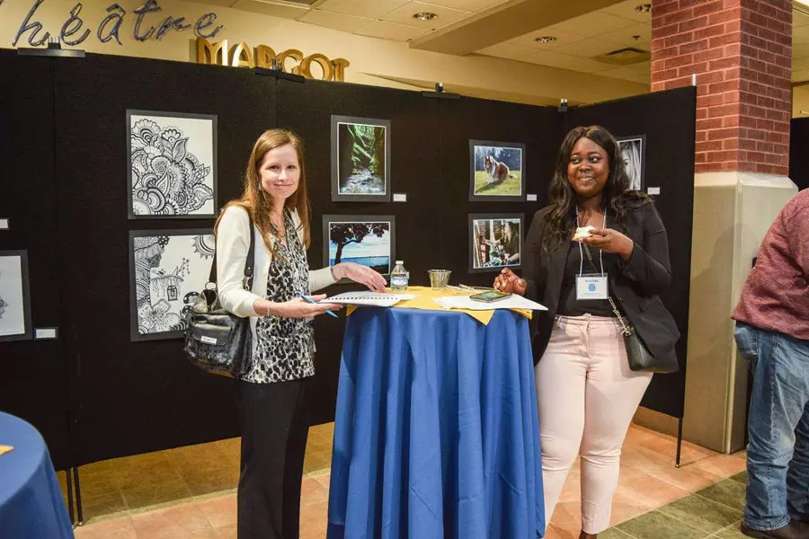 USI psychology faculty member poses with a student at an event