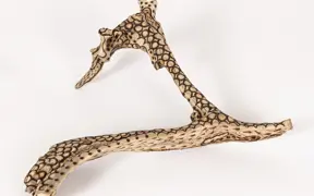 tattooed wood art piece
