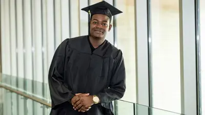 USI student in his cap and gown