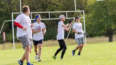 Members of the Ultimate Frisbee Club throwing a disc
