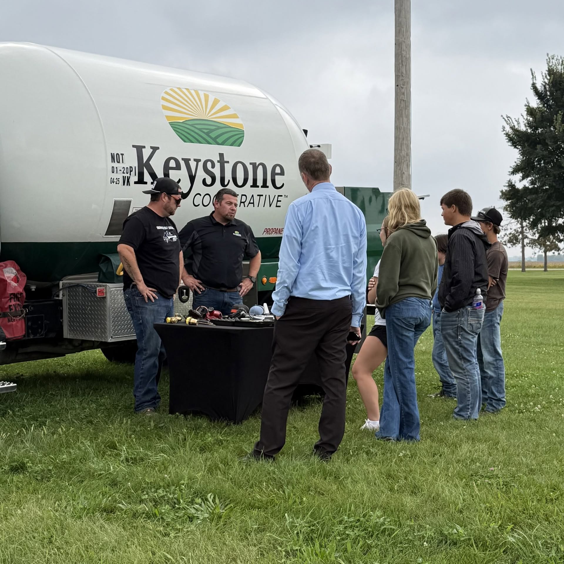 Students engage with Keystone Cooperative representatives during an outdoor agricultural education demonstration.