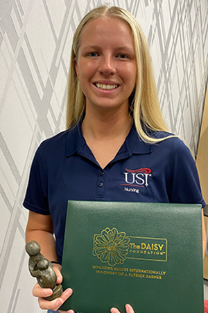 Lily Sinnett holding Daisy certificate