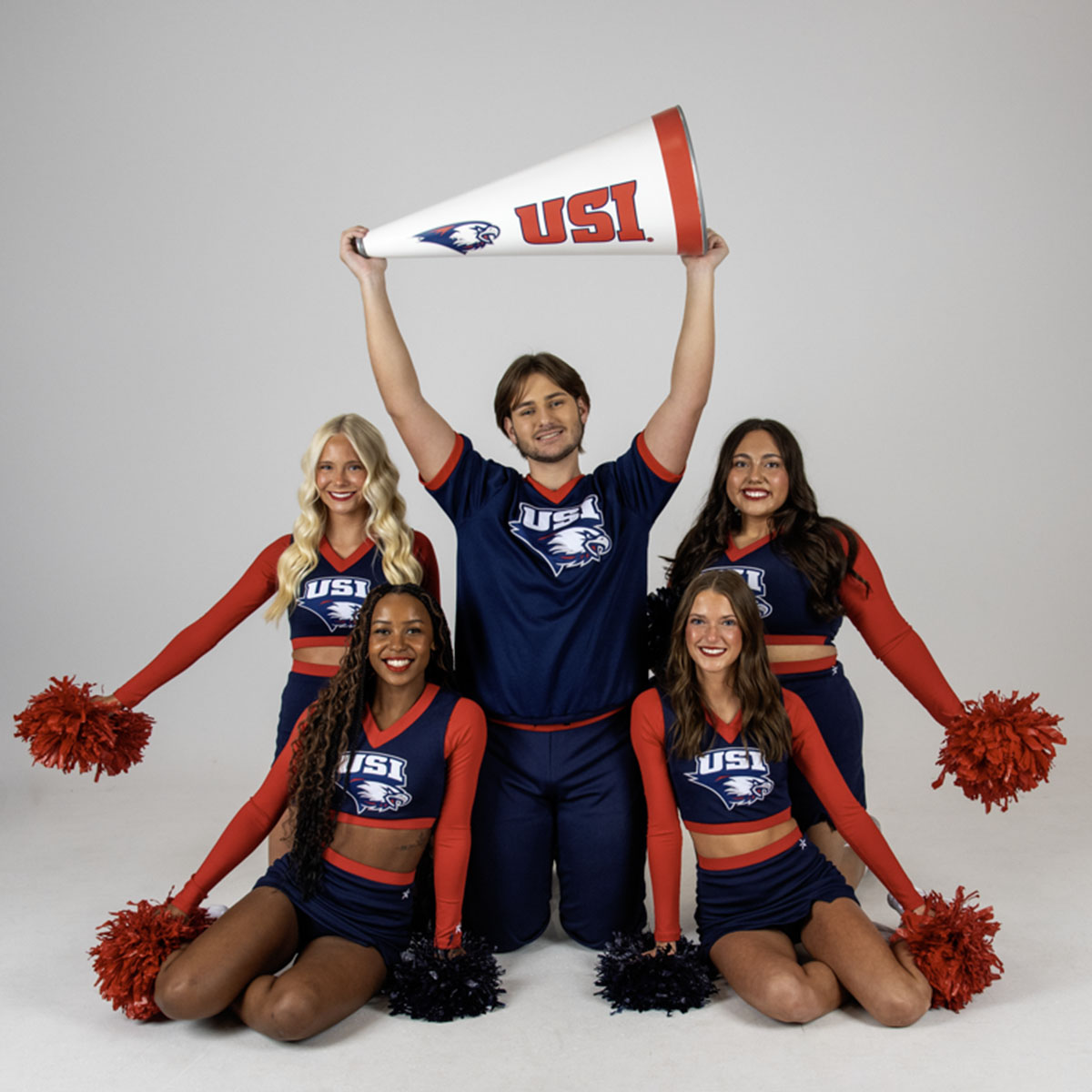Members of USI's Cheer Team posing together for their media day photos. 