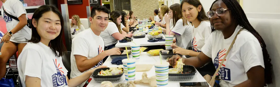Student orientation leaders have lunch together in the Loft