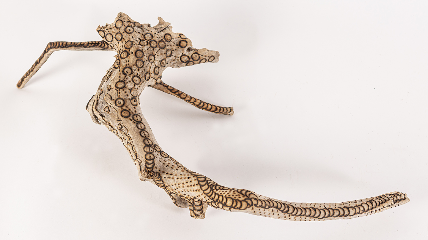 tattooed wood art piece